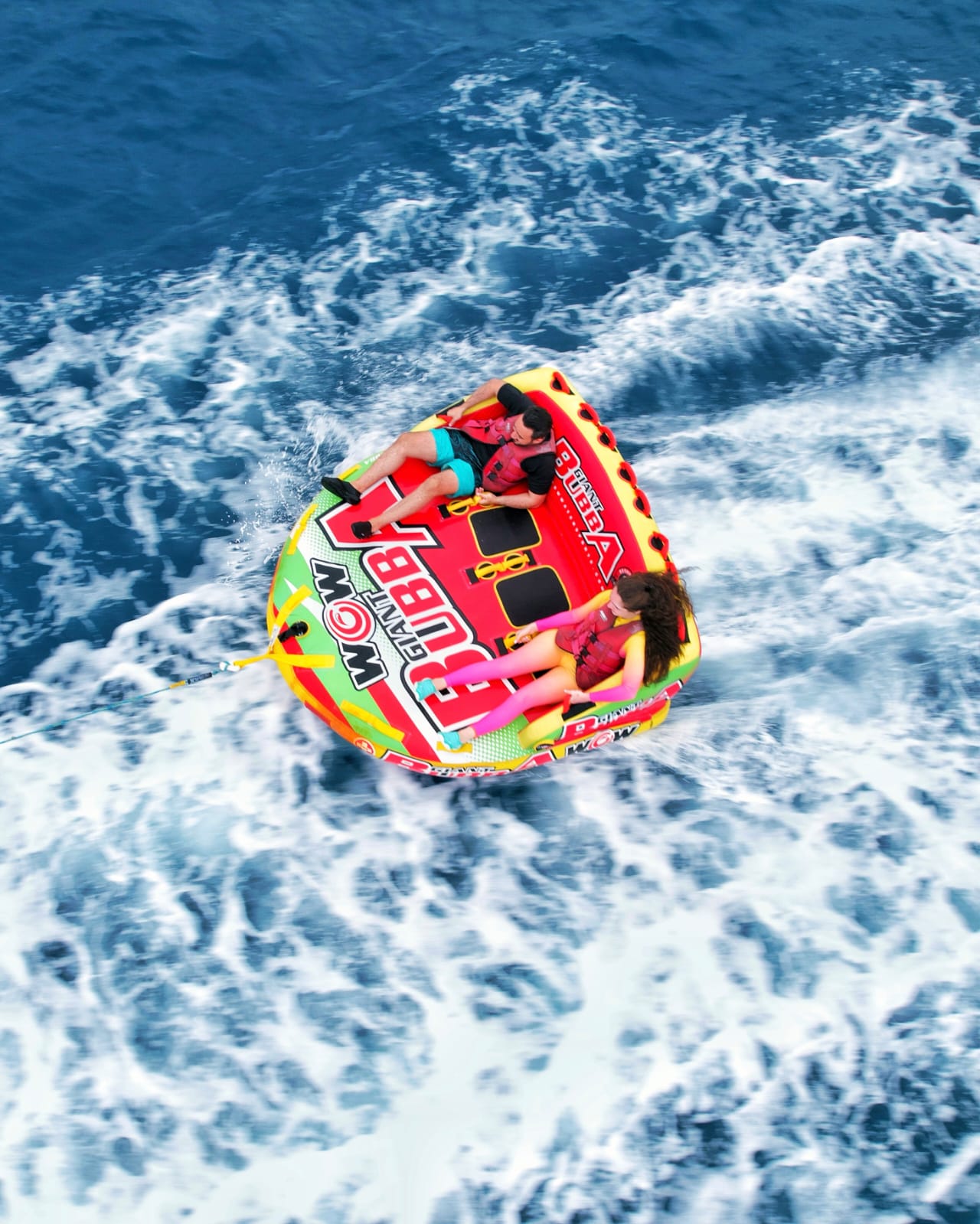 Two guests tubing across the Maldives sea